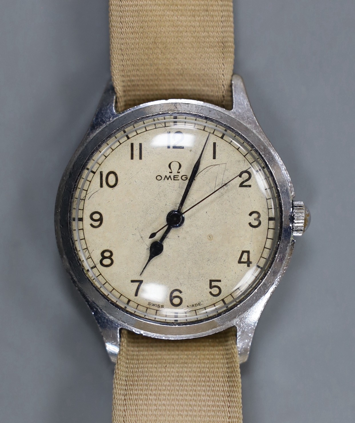 A gentleman's early 1940's stainless steel Omega manual wind wrist watch, on associated fabric strap.